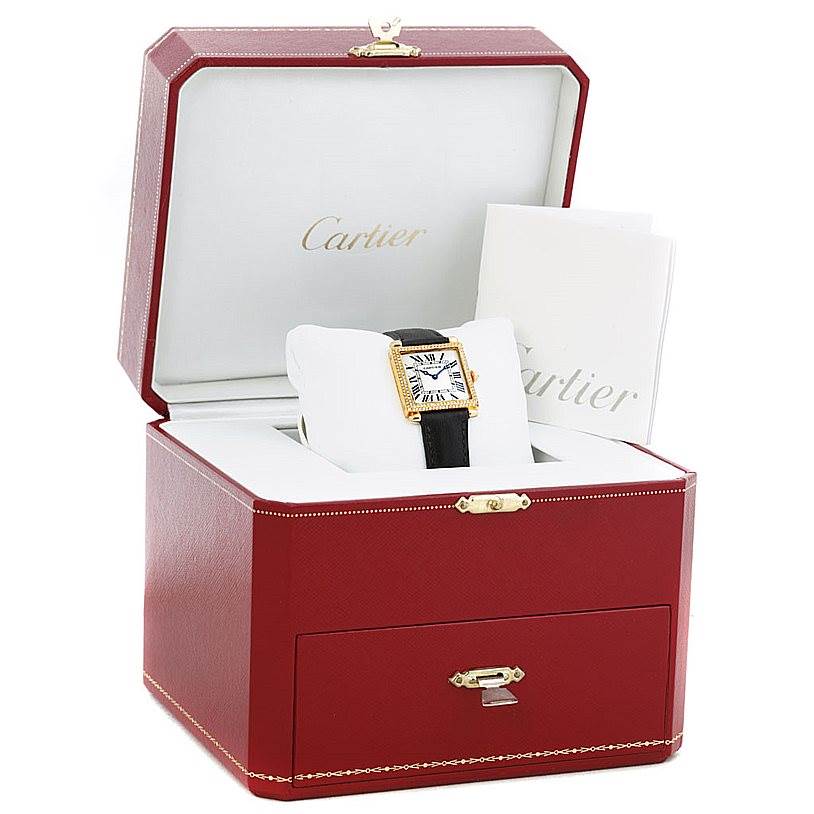 The image shows a Cartier Tank Obus W1512256 Men's Yellow Gold Silver Dial W1512256 Men's Yellow Gold Silver Dial watch displayed in an open red Cartier box with accompanying booklets.