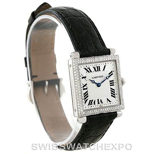 This image shows a side-angle view of a Cartier Tank Obus Men's White Gold Silver Dial Men's White Gold Silver Dial watch, highlighting its square face, Roman numerals, and black leather strap.