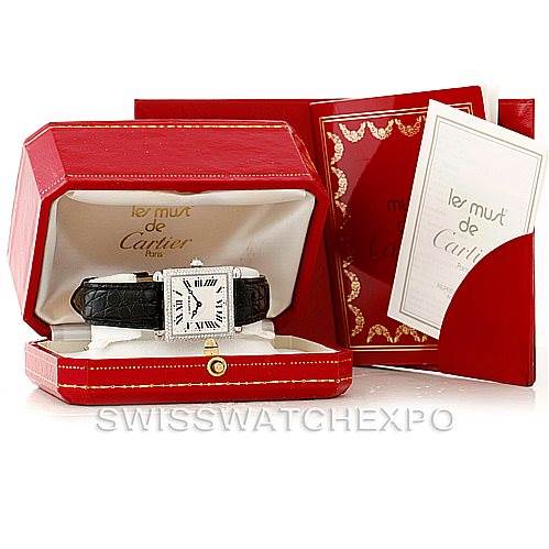 The Tank Obus model by Cartier is shown in its case, along with additional packaging and cards at an angled view.