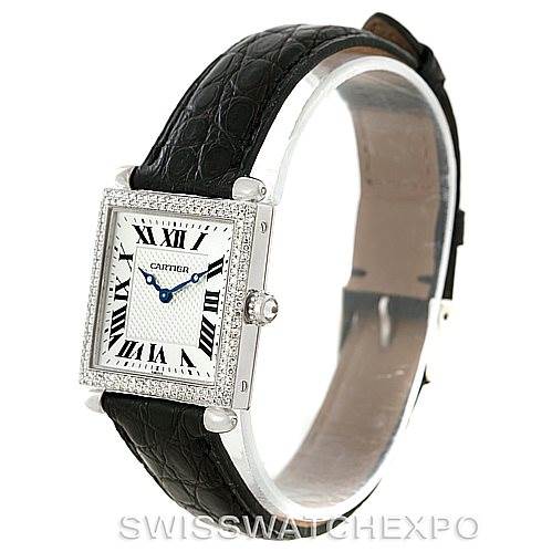 This image shows a Cartier Tank Obus Men's White Gold Silver Dial Men's White Gold Silver Dial watch at an angle highlighting the face, case, crown, and black leather strap.