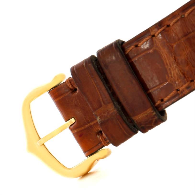 This image shows the buckle and part of the leather strap of a Cartier Tank Obus 1630 Men's Yellow Gold Silver Dial 1630 Men's Yellow Gold Silver Dial watch.
