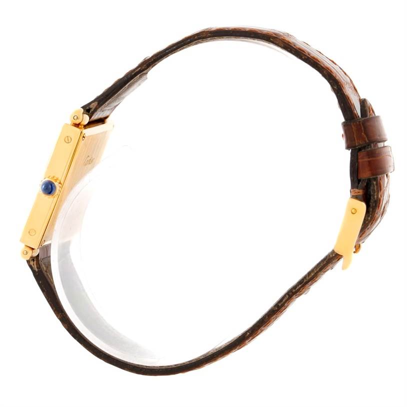 The image shows a side profile of a Cartier Tank Obus 1630 Men's Yellow Gold Silver Dial 1630 Men's Yellow Gold Silver Dial model watch, highlighting the case, crown, and brown leather strap.