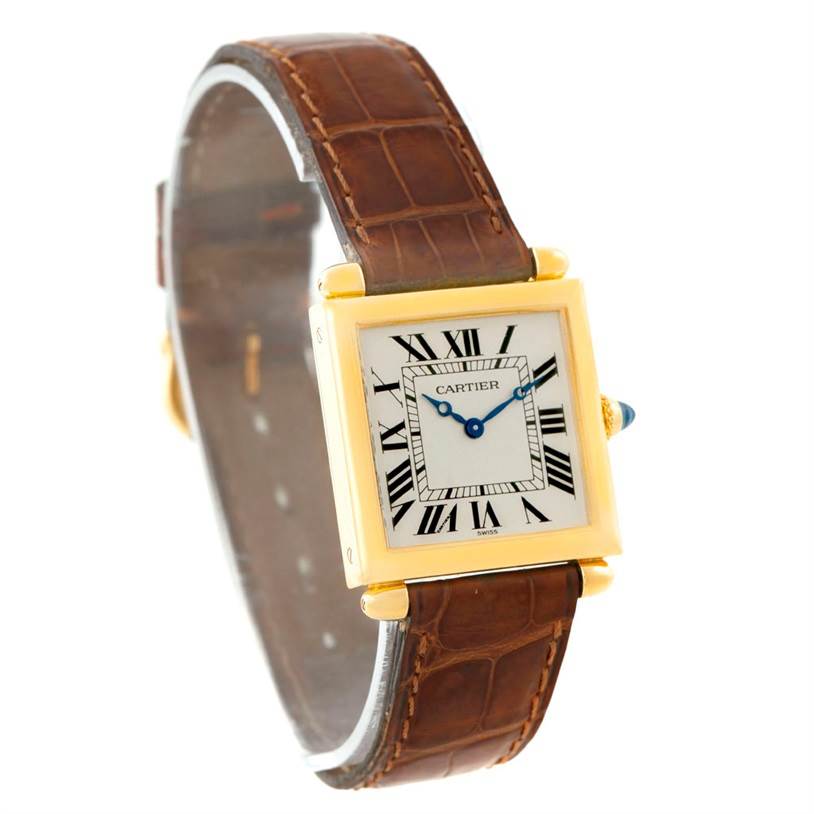 The image shows a Cartier Tank Obus 1630 Men's Yellow Gold Silver Dial 1630 Men's Yellow Gold Silver Dial watch angled to display its gold rectangular case, Roman numeral dial, and brown leather strap.