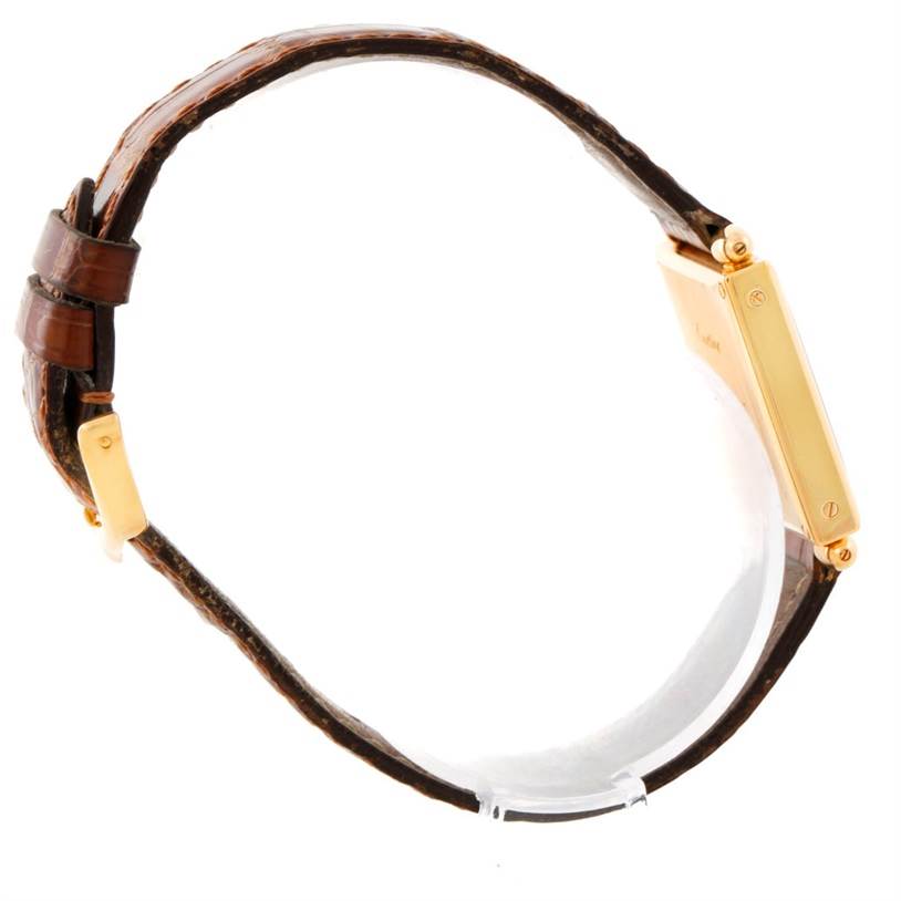 The image shows a side view of the Cartier Tank Obus 1630 Men's Yellow Gold Silver Dial 1630 Men's Yellow Gold Silver Dial watch, highlighting its case, crown, and brown leather strap.