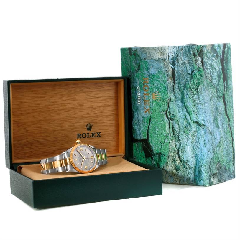 The Rolex Oyster Perpetual 14233 Men's Steel and Gold (two tone) Grey Dial 14233 Men's Steel and Gold (two tone) Grey Dial watch is shown in its opened box with the outer box beside it.