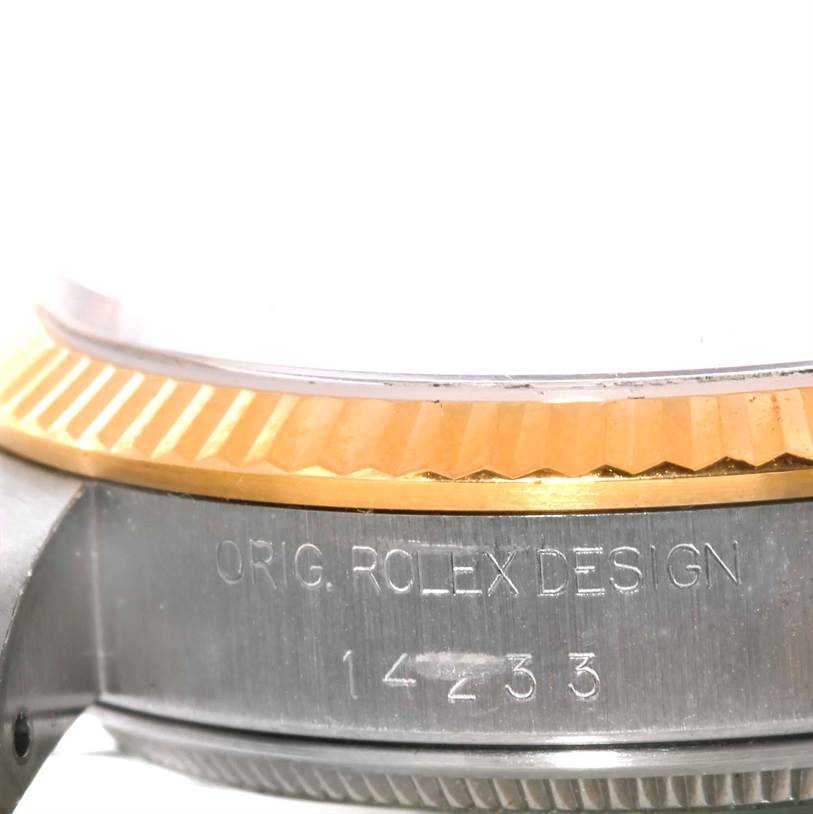 The image shows a close-up of the case and fluted bezel of an Oyster Perpetual model by Rolex, highlighting the "ORIG. ROLEX DESIGN" engraving.