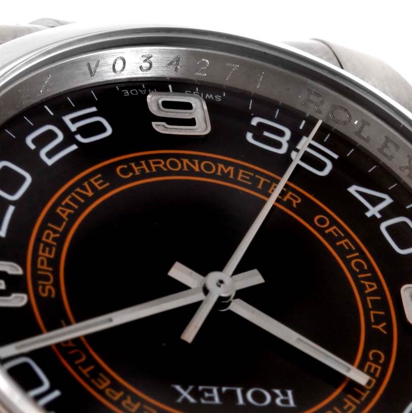 The image shows a close-up of the dial and bezel of the Rolex Oyster Perpetual 116000 Men
s Stainless Steel Black Dial 116000 Men
s Stainless Steel Black Dial watch, focusing on the number 9 and surrounding text.
