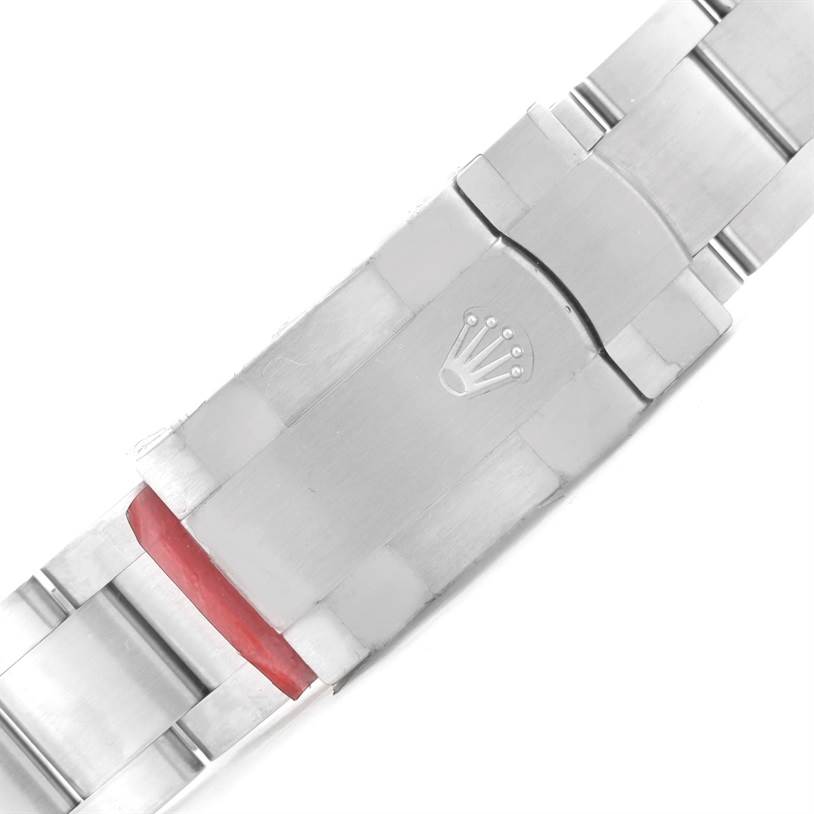 The image shows the clasp of the Oyster Perpetual by Rolex from a top-down angle.