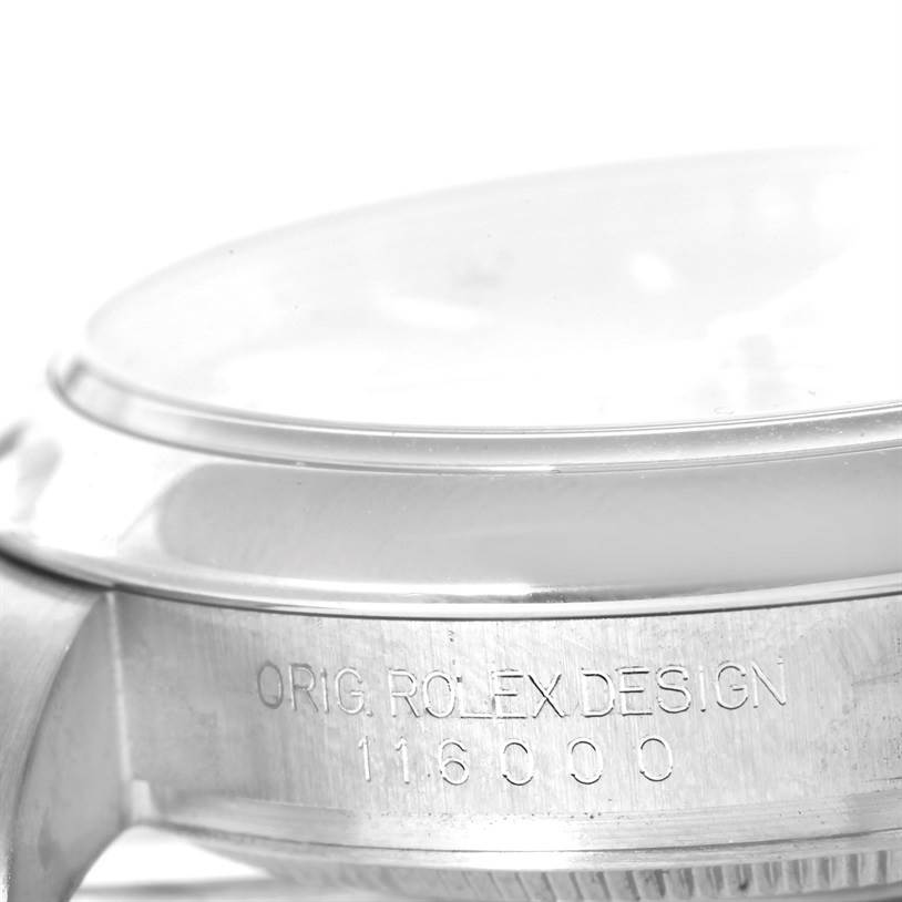 This image shows a close-up side view of a Rolex Oyster Perpetual 116000 Stainless Steel Silver Dial 116000 Stainless Steel Silver Dial watch, highlighting the case and model number engraving.