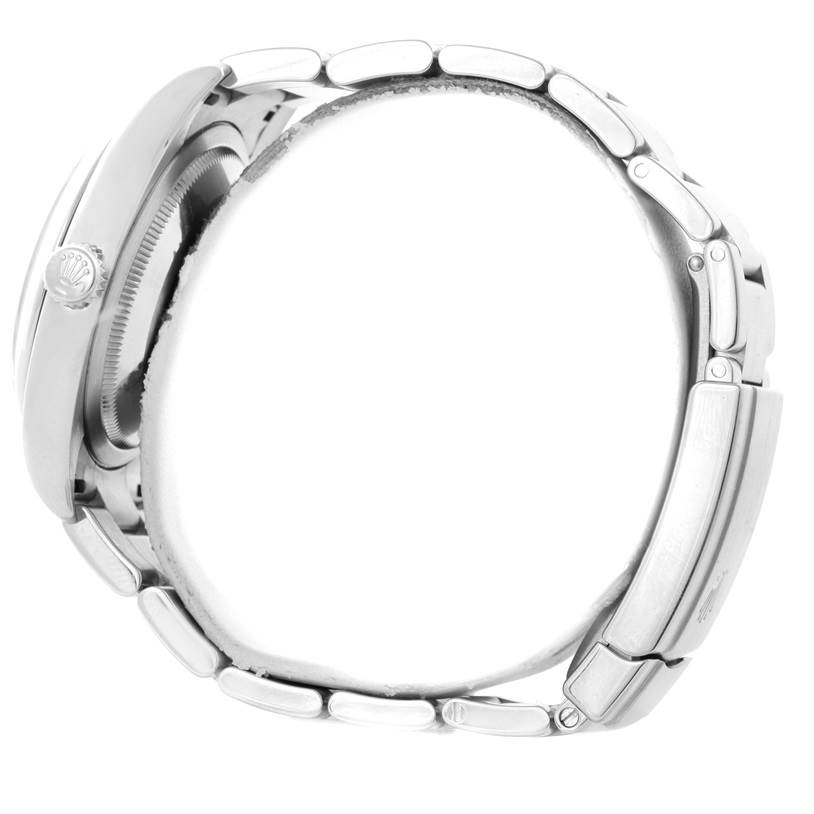 The image shows the side view of a Rolex Oyster Perpetual 116000 Men's Stainless Steel Black Dial 116000 Men's Stainless Steel Black Dial watch, highlighting the case, bezel, crown, and part of the bracelet.