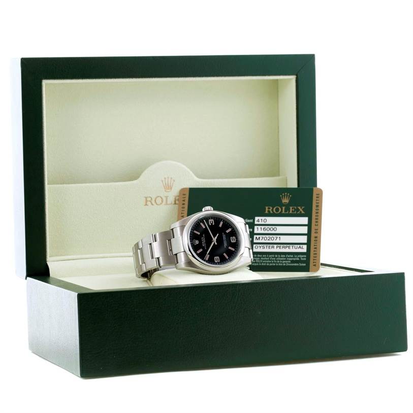 The image shows a Rolex Oyster Perpetual 116000 Men's Stainless Steel Black Dial 116000 Men's Stainless Steel Black Dial watch along with its box and authentication card, photographed from the front.