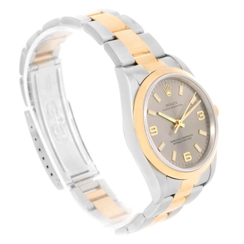 The Rolex Oyster Perpetual 14203 Men's Steel and Gold (two tone) Grey Dial 14203 Men's Steel and Gold (two tone) Grey Dial watch is shown at a slight angle, displaying the dial, bezel, and part of the bracelet.