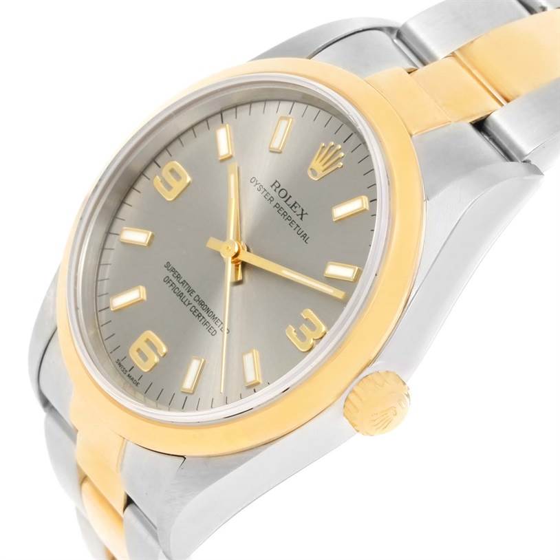 The image shows a close-up angle of a Rolex Oyster Perpetual 14203 Men's Steel and Gold (two tone) Grey Dial 14203 Men's Steel and Gold (two tone) Grey Dial watch, highlighting its gold and silver case, dial, and crown.