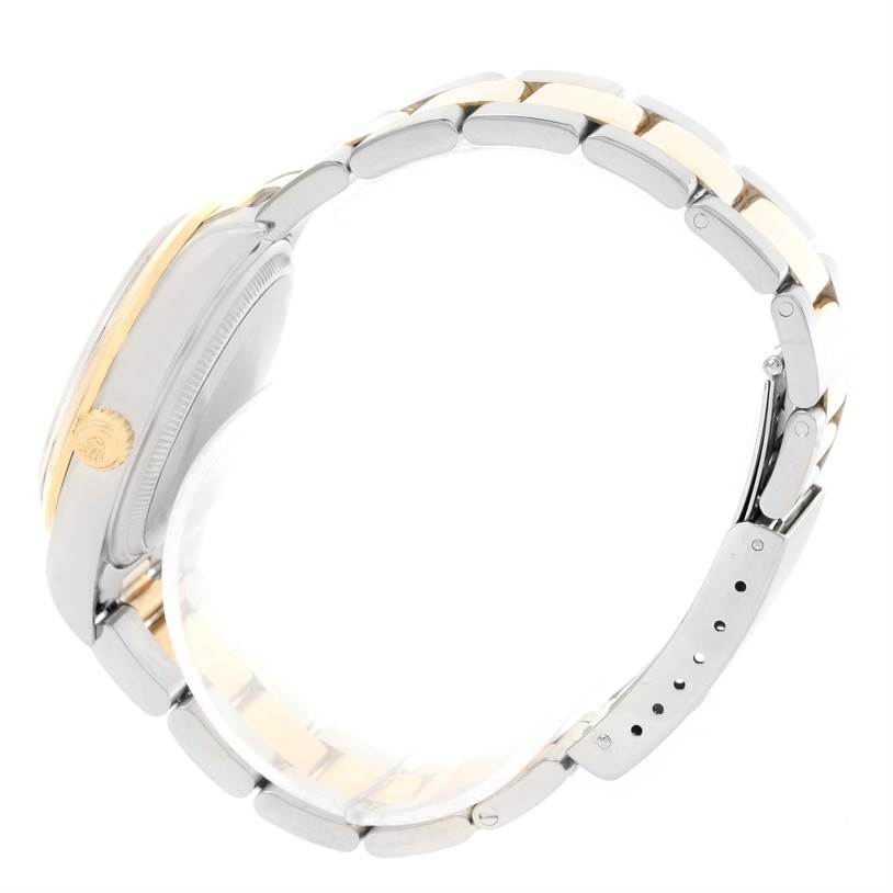 The image shows a side view of the Rolex Oyster Perpetual 14203 Men's Steel and Gold (two tone) Grey Dial 14203 Men's Steel and Gold (two tone) Grey Dial's case, crown, and bracelet, highlighting its metal finish.