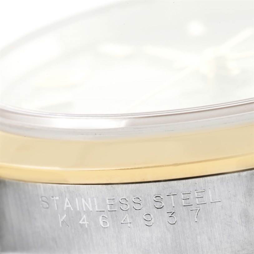 The image shows a close-up of the side of a Rolex Oyster Perpetual 14203 Men's Steel and Gold (two tone) Grey Dial 14203 Men's Steel and Gold (two tone) Grey Dial watch, highlighting the stainless steel casing and serial number.