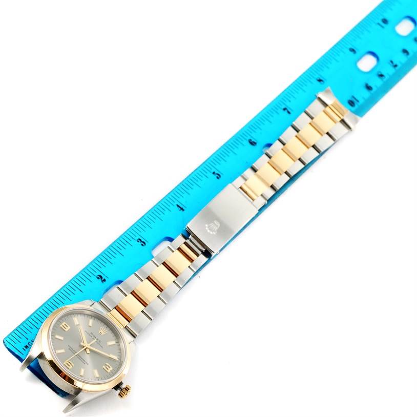 The image shows a Rolex Oyster Perpetual 14203 Men's Steel and Gold (two tone) Grey Dial 14203 Men's Steel and Gold (two tone) Grey Dial watch laid flat, featuring its two-tone bracelet and case, measured against a blue ruler.