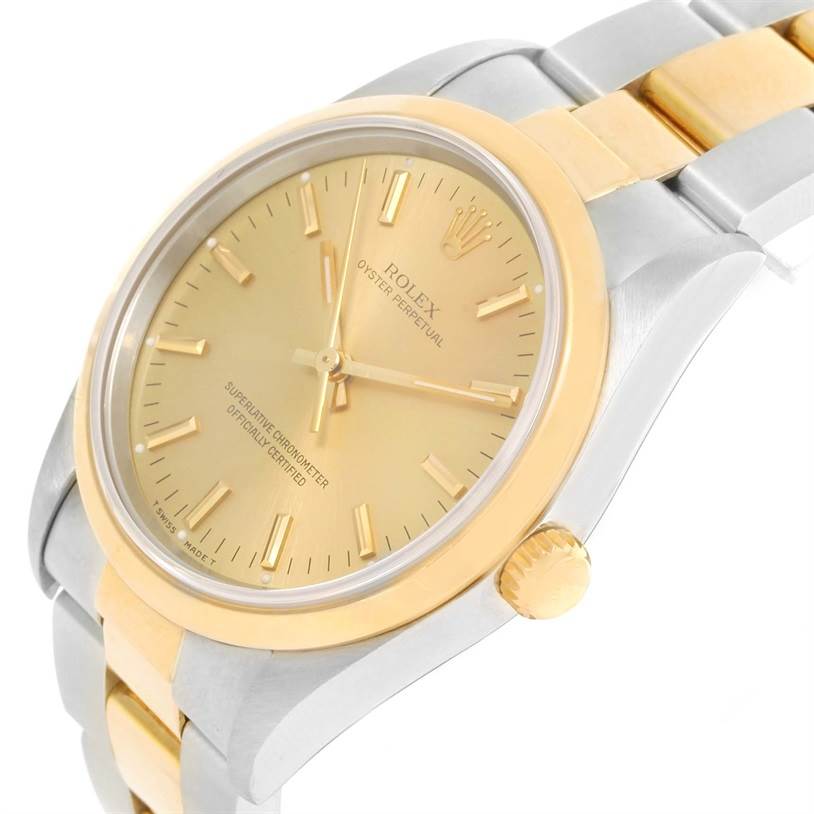 This image shows the Rolex Oyster Perpetual 14203 Men
s Steel and Gold (two tone) Champagne Dial 14203 Men
s Steel and Gold (two tone) Champagne Dial from an angled close-up, highlighting the dial, bezel, crown, and part of the bracelet.