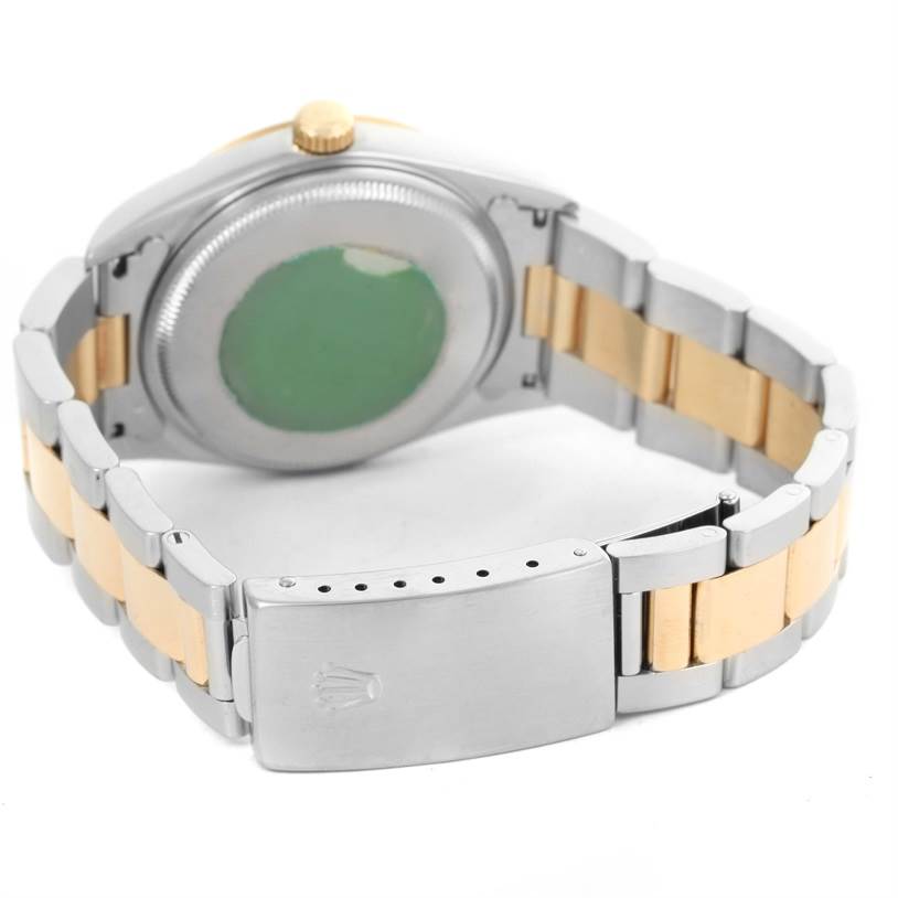 The image shows the back view of the Rolex Oyster Perpetual 14203 Men
s Steel and Gold (two tone) Champagne Dial 14203 Men
s Steel and Gold (two tone) Champagne Dial watch, displaying the bracelet and clasp.