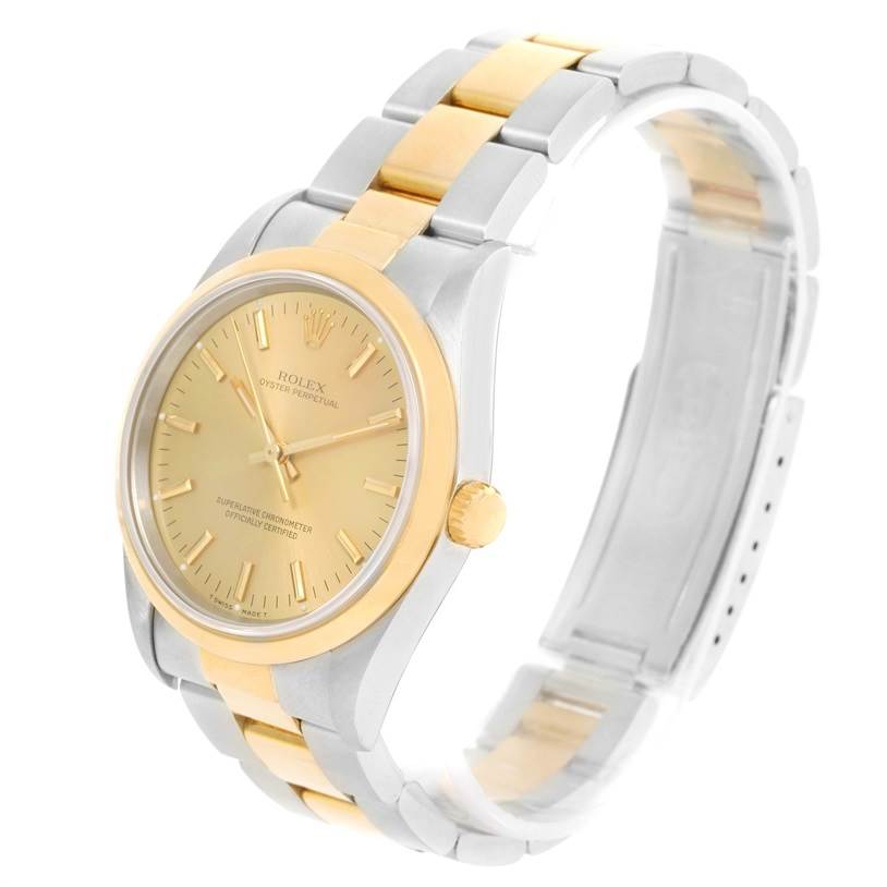 The image shows a Rolex Oyster Perpetual 14203 Men
s Steel and Gold (two tone) Champagne Dial 14203 Men
s Steel and Gold (two tone) Champagne Dial watch at a three-quarter angle, highlighting its gold and silver bracelet and dial.