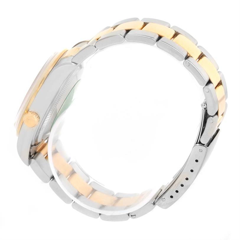 The image shows the side view of a Rolex Oyster Perpetual 14203 Men
s Steel and Gold (two tone) Champagne Dial 14203 Men
s Steel and Gold (two tone) Champagne Dial watch, focusing on the bracelet and crown.