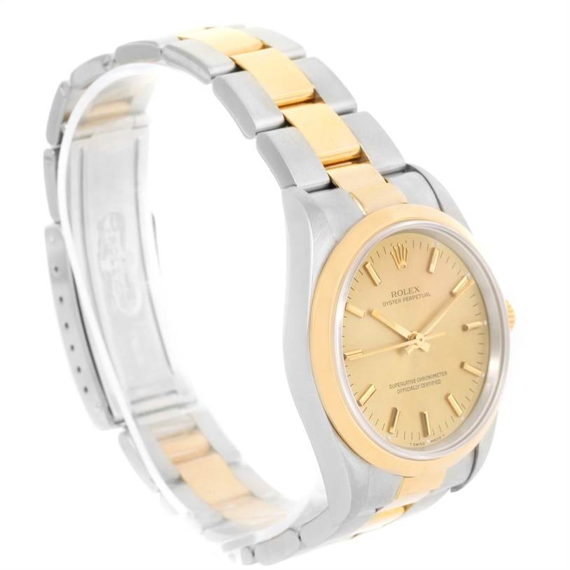 The Rolex Oyster Perpetual 14203 Men
s Steel and Gold (two tone) Champagne Dial 14203 Men
s Steel and Gold (two tone) Champagne Dial watch is shown at a front-side angle, highlighting its dial, case, and two-tone bracelet.
