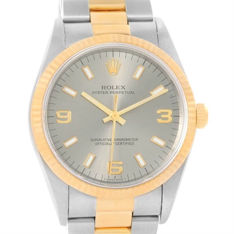 The Rolex Oyster Perpetual 14233 Men's Steel and Gold (two tone) Grey Dial 14233 Men's Steel and Gold (two tone) Grey Dial watch is shown from a front view, highlighting its dial, bezel, crown, and part of the bracelet.
