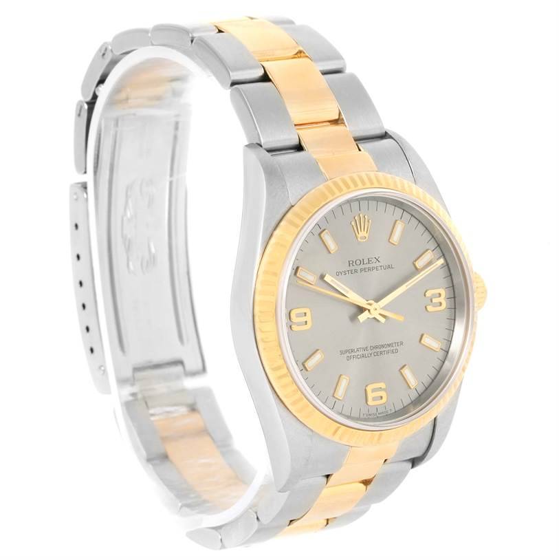 This image shows a side angle of a Rolex Oyster Perpetual watch, highlighting its two-tone bracelet and dial.