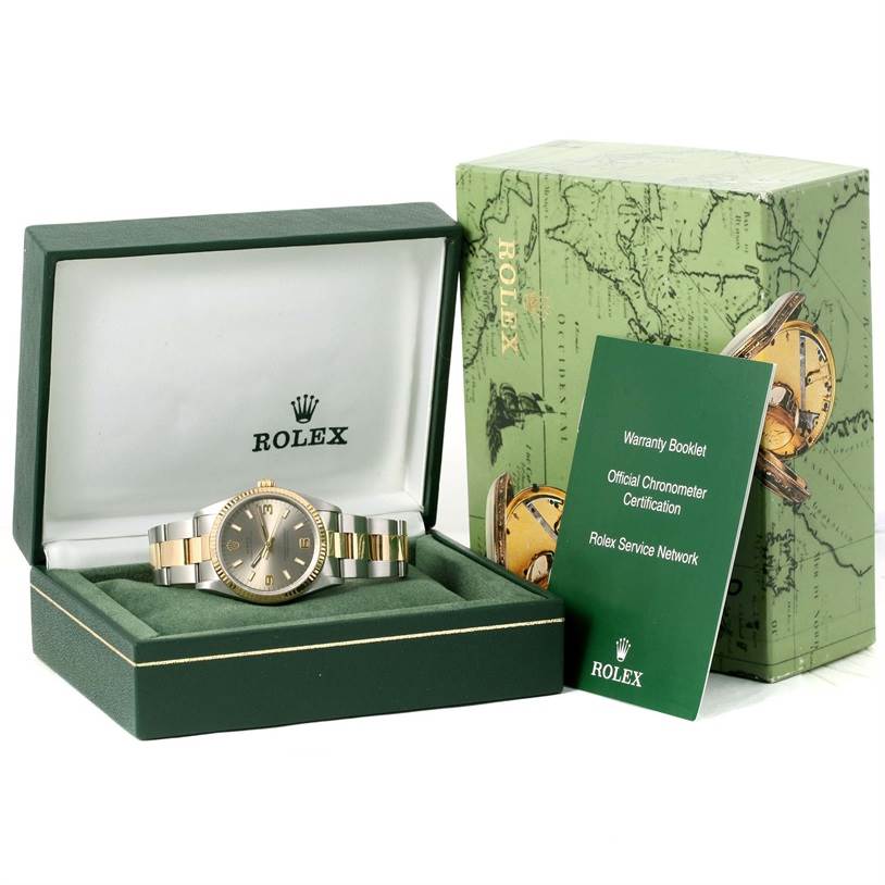 The image shows a Rolex Oyster Perpetual 14233 Men's Steel and Gold (two tone) Grey Dial 14233 Men's Steel and Gold (two tone) Grey Dial watch from a front angle in its box, accompanied by a warranty booklet and outer packaging.
