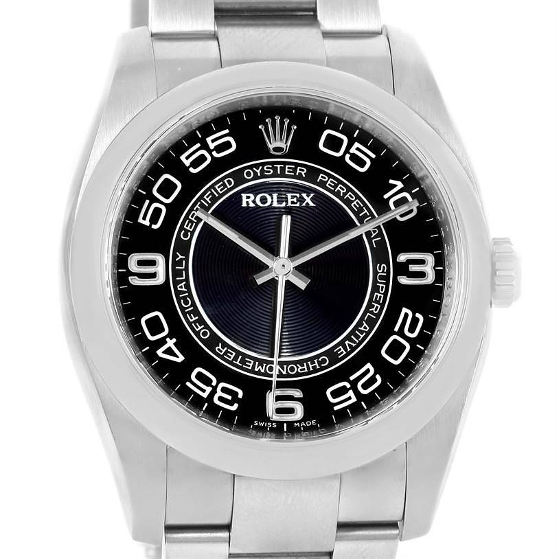 The image shows a front view of a Rolex Oyster Perpetual watch displaying the face, bezel, and part of the bracelet.