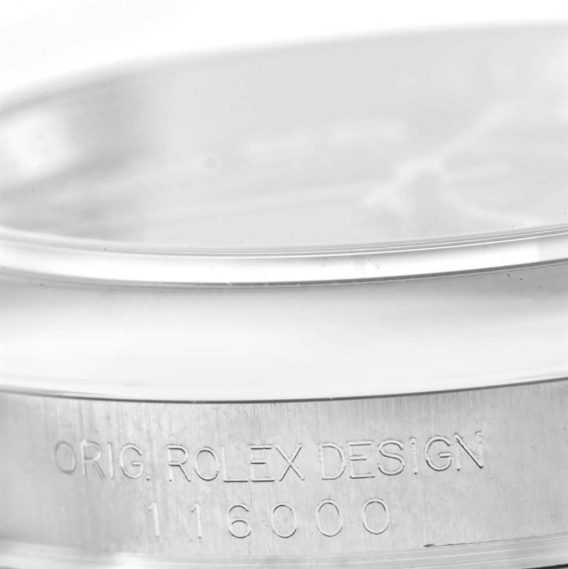 This image shows a close-up of the case side of a Rolex Oyster Perpetual 116000 Men's Stainless Steel Black Dial 116000 Men's Stainless Steel Black Dial watch, highlighting its engraved model number, 116000.