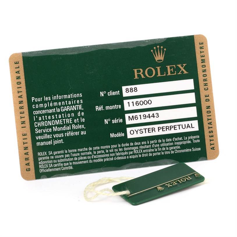 The image shows a warranty card and a tag for the Rolex Oyster Perpetual 116000 Men's Stainless Steel Black Dial 116000 Men's Stainless Steel Black Dial model.