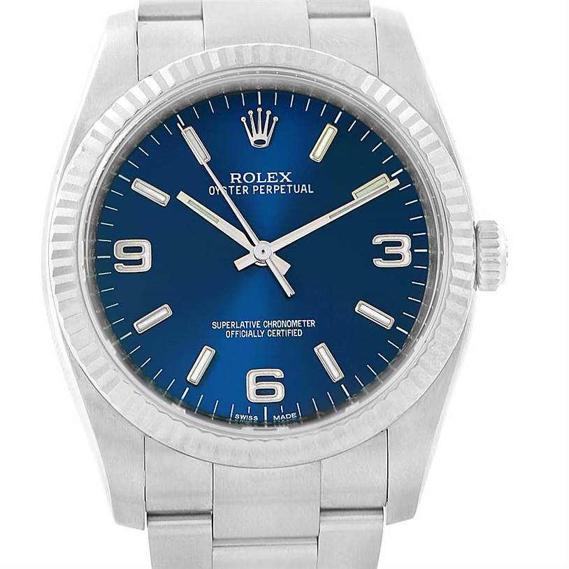 This is a frontal close-up view of a Rolex Oyster Perpetual watch, showing the blue dial, hour markers, hands, and part of the bracelet.