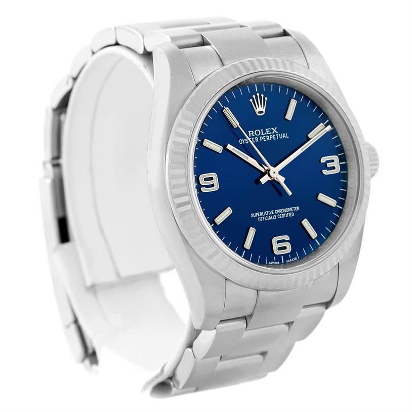 The image shows a Rolex Oyster Perpetual 116034 Men
s Stainless Steel Blue Dial 116034 Men
s Stainless Steel Blue Dial watch at a front-left angle, displaying its blue dial and metal bracelet.