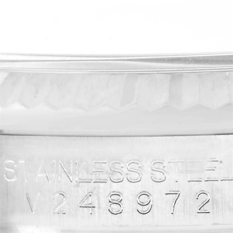 This close-up angle shows the serial number engraved on the stainless steel casing of the Rolex Oyster Perpetual 116034 Men
s Stainless Steel Blue Dial 116034 Men
s Stainless Steel Blue Dial watch.