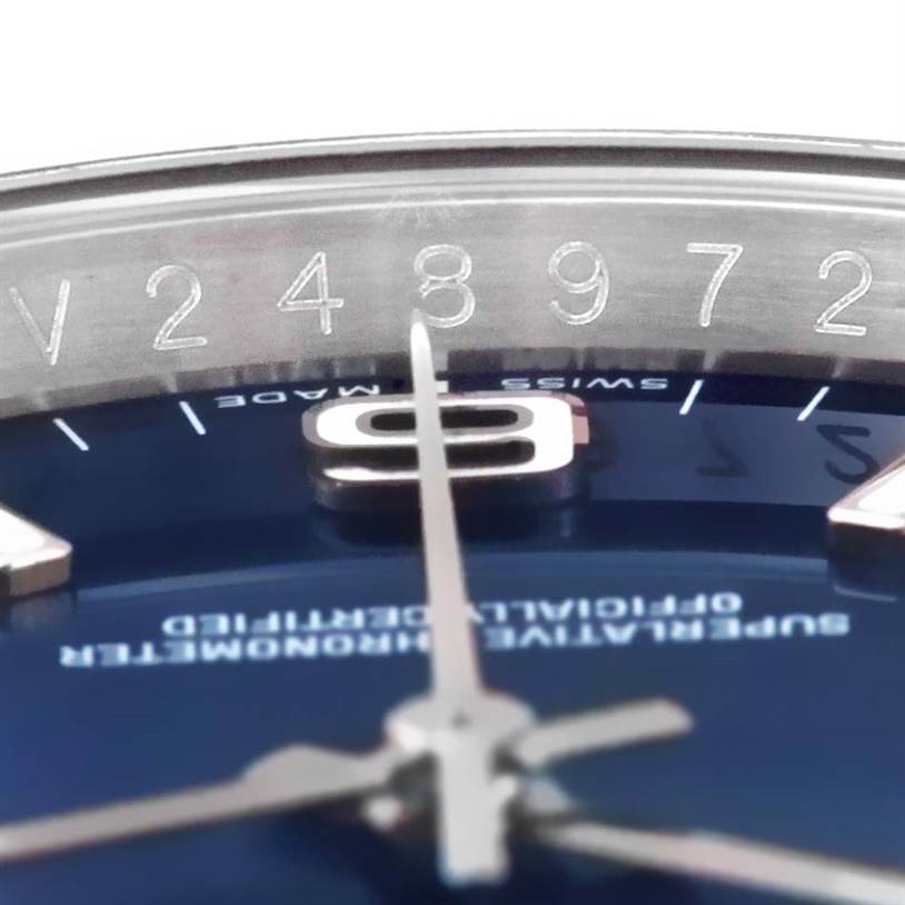 This close-up image of the Rolex Oyster Perpetual 116034 Men
s Stainless Steel Blue Dial 116034 Men
s Stainless Steel Blue Dial watch shows part of the dial, the hour markers, and part of the hands.