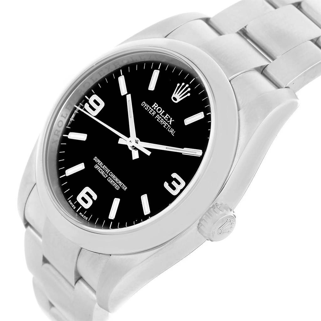 The image shows a Rolex Oyster Perpetual 116000 Men's Stainless Steel Black Dial 116000 Men's Stainless Steel Black Dial watch, captured from an angled side view displaying the face, bezel, crown, and part of the bracelet.