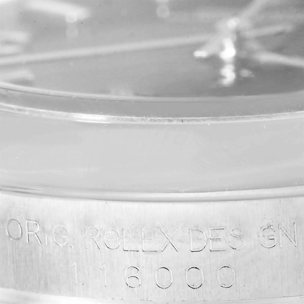 The close-up image shows the engraved model number and design inscription on the side of a Rolex Oyster Perpetual 116000 Men's Stainless Steel Black Dial 116000 Men's Stainless Steel Black Dial watch case.