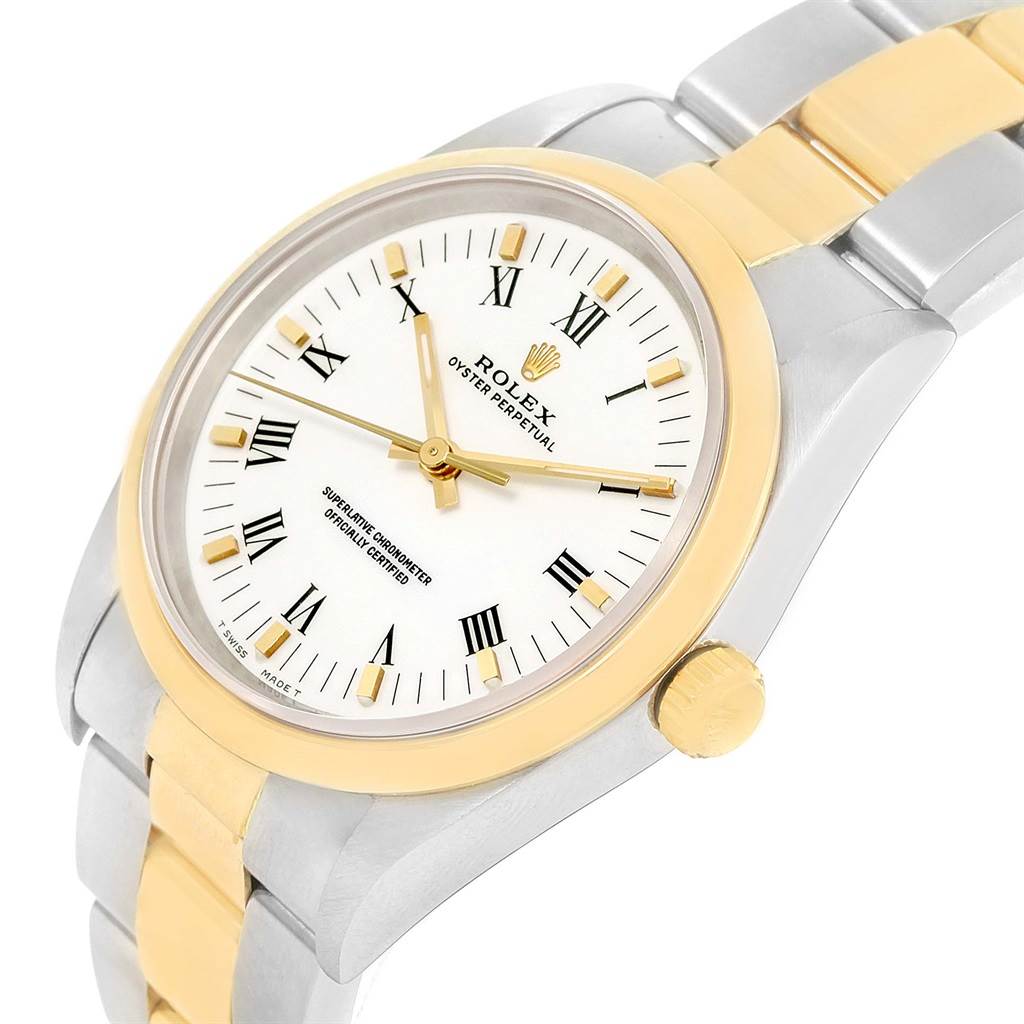 This image shows a Rolex Oyster Perpetual 14203 Men
s Steel and Gold (two tone) White Dial 14203 Men
s Steel and Gold (two tone) White Dial watch at an angled view, highlighting the face, bezel, crown, and part of the bracelet.