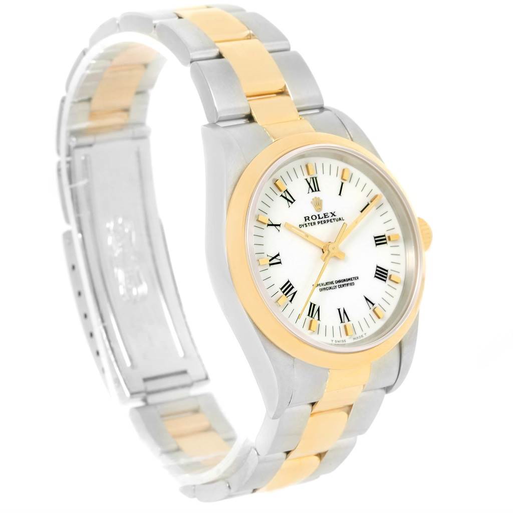 This Rolex Oyster Perpetual 14203 Men
s Steel and Gold (two tone) White Dial 14203 Men
s Steel and Gold (two tone) White Dial watch is shown at a slight angle, highlighting its two-tone bracelet, bezel, and white dial with Roman numerals.