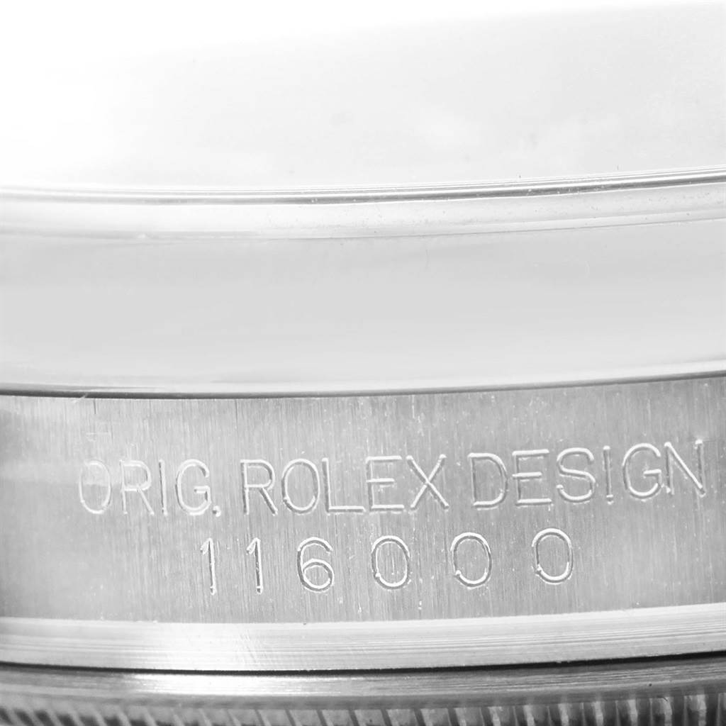 The image shows an inscription on the side of the casing of a Rolex Oyster Perpetual 116000 Men's Stainless Steel Black Dial 116000 Men's Stainless Steel Black Dial watch, displaying "ORIG. ROLEX DESIGN 116000".