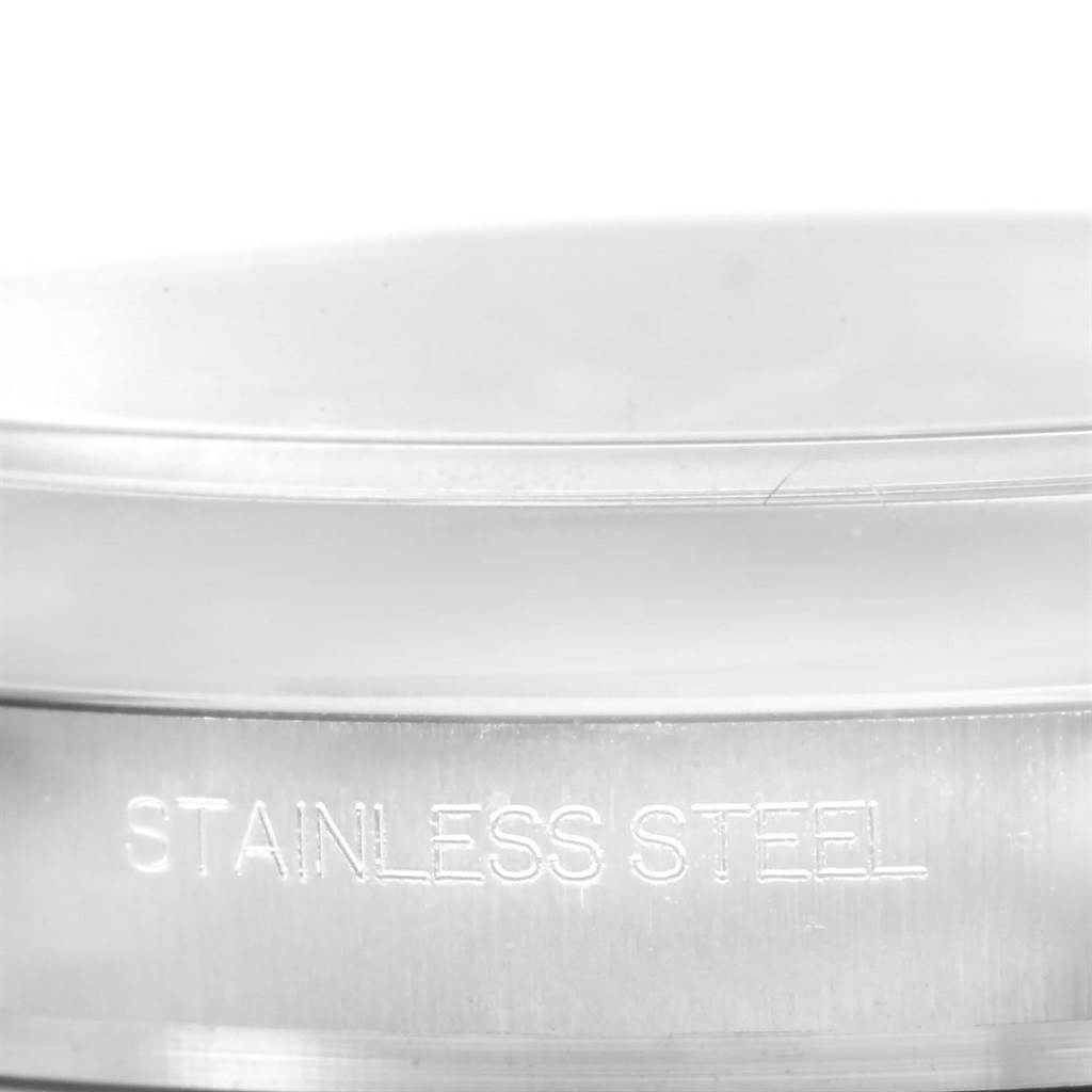 This image shows a close-up angle of the case back of a Rolex Oyster Perpetual 116000 Men
s Stainless Steel Blue Dial 116000 Men
s Stainless Steel Blue Dial watch, highlighting the "Stainless Steel" engraving.