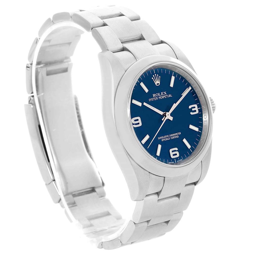 The Rolex Oyster Perpetual 116000 Men
s Stainless Steel Blue Dial 116000 Men
s Stainless Steel Blue Dial watch is shown at a slight side angle, highlighting the bracelet, dial, and crown.