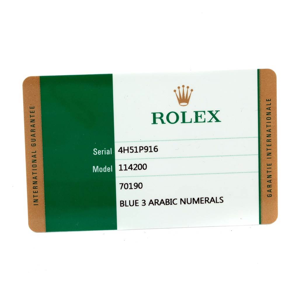 The image shows the international guarantee card for the Rolex Oyster Perpetual 114200 Men's Stainless Steel Blue Dial 114200 Men's Stainless Steel Blue Dial model 114200.
