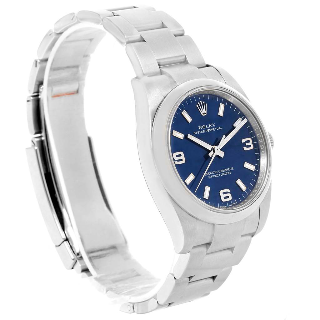 The Rolex Oyster Perpetual 114200 Men's Stainless Steel Blue Dial 114200 Men's Stainless Steel Blue Dial watch is shown at a slight angle, highlighting the face, bezel, and bracelet.