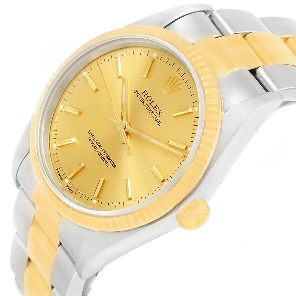 This image shows a side and partial front view of a Rolex Oyster Perpetual 14233 Men's Steel and Gold (two tone) Champagne Dial 14233 Men's Steel and Gold (two tone) Champagne Dial watch, featuring its face, bezel, and part of the bracelet.