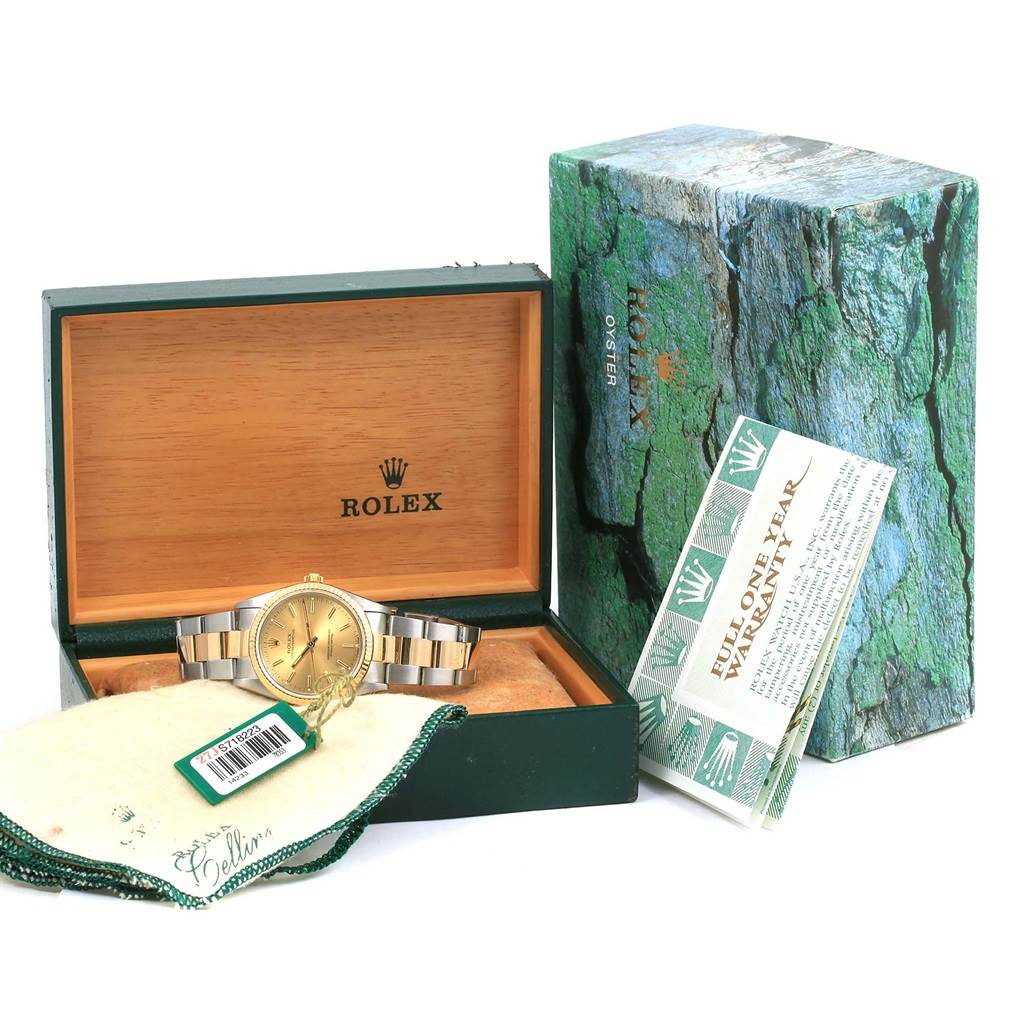 The image shows a Rolex Oyster Perpetual 14233 Men's Steel and Gold (two tone) Champagne Dial 14233 Men's Steel and Gold (two tone) Champagne Dial watch in its box, accompanied by a warranty card and a tag.