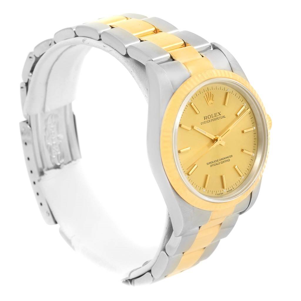 This image shows a Rolex Oyster Perpetual 14233 Men's Steel and Gold (two tone) Champagne Dial 14233 Men's Steel and Gold (two tone) Champagne Dial watch from a front-side angle, highlighting its two-tone bracelet and gold dial.