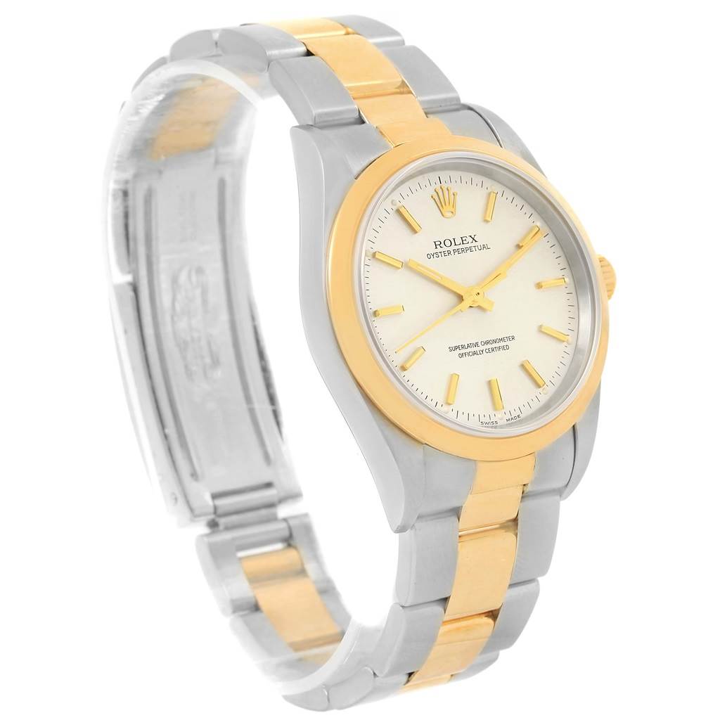 The Rolex Oyster Perpetual 14203 Men's Steel and Gold (two tone) Silver Dial 14203 Men's Steel and Gold (two tone) Silver Dial watch is shown at a three-quarter angle, highlighting its two-tone band and face details.