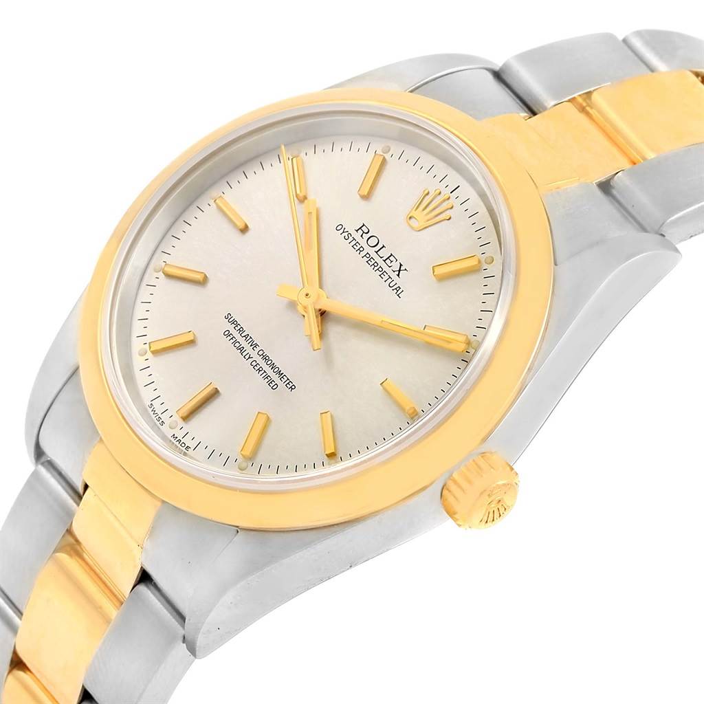 The image shows a close-up angle of the Rolex Oyster Perpetual 14203 Men's Steel and Gold (two tone) Silver Dial 14203 Men's Steel and Gold (two tone) Silver Dial watch's face and part of the bracelet.