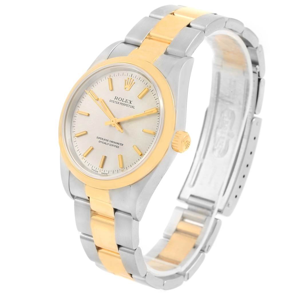 The image shows a Rolex Oyster Perpetual 14203 Men's Steel and Gold (two tone) Silver Dial 14203 Men's Steel and Gold (two tone) Silver Dial watch at an angle displaying its face, bezel, case, and part of its bracelet.